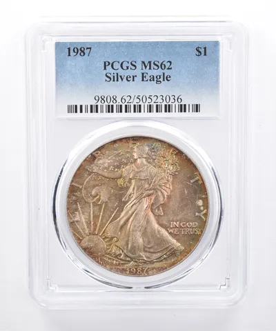 1987 American Silver Eagle MS62 PCGS Yellow/Green Tone *8504