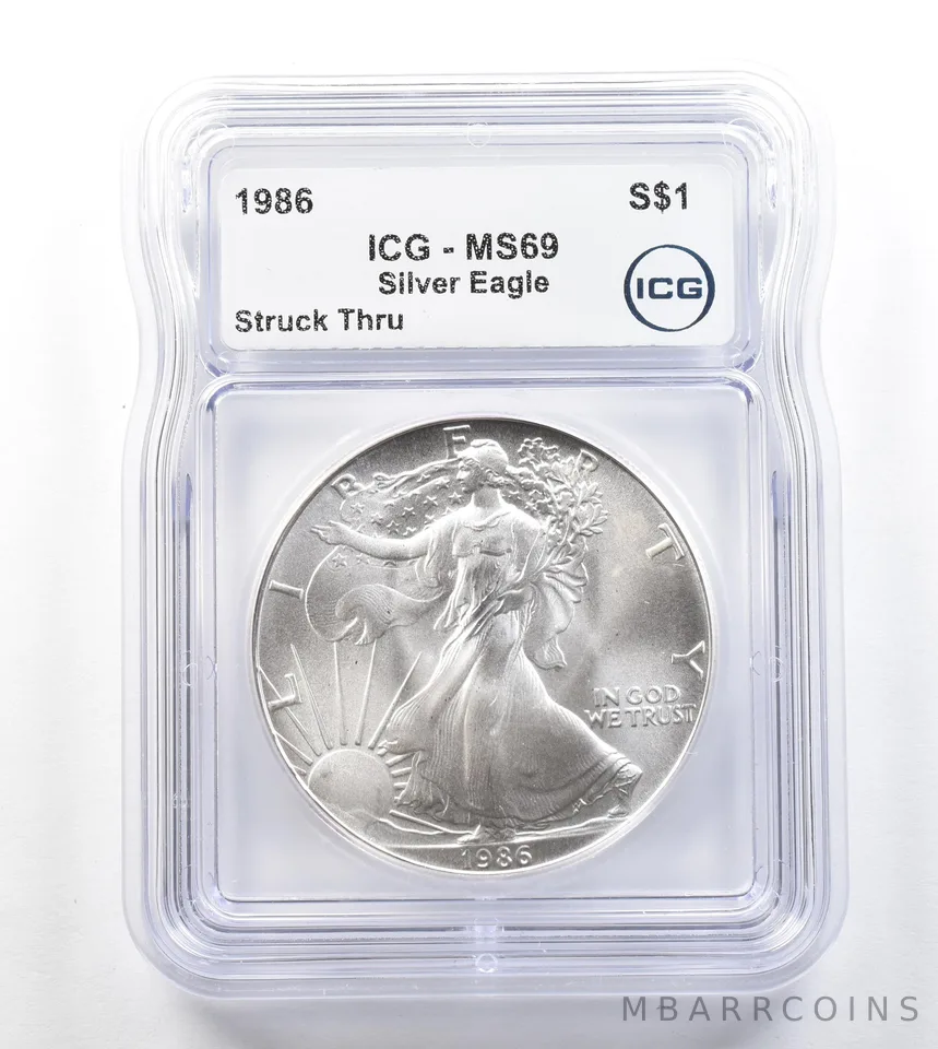 1986 American Silver Eagle Mint Error Struck Thru MS69 ICG a3292