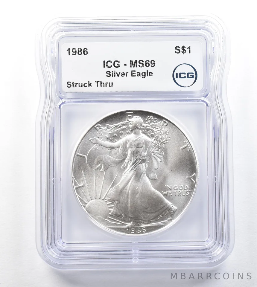 1986 American Silver Eagle Mint Error Struck Thru MS69 ICG a3294