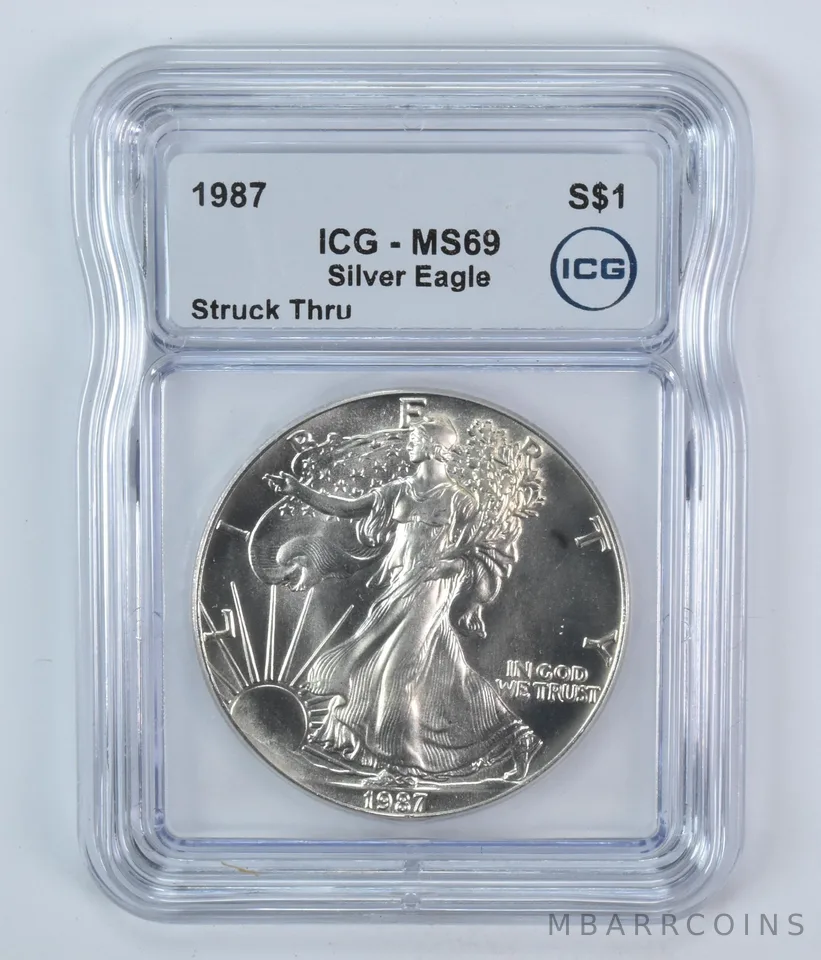 1987 American Silver Eagle Mint Error Struck Thru MS69 ICG